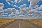 USA, Washington State. Highway 26 just west of Washtucna with clouds over wheat fields Art Print